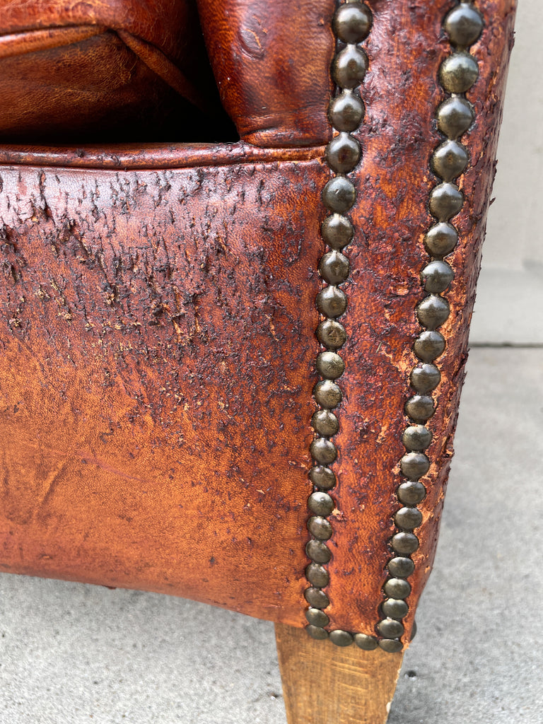 Pair Distressed Vintage European Leather Tub Chairs with Brass Nailhead Detail